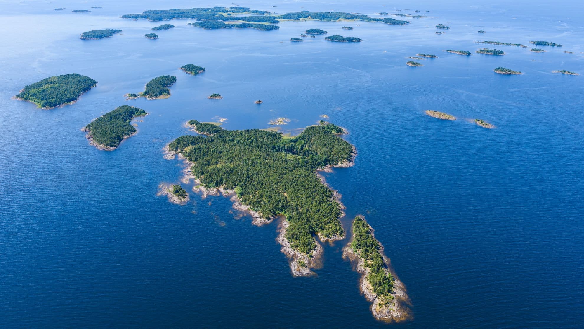 Angler fishing on a Nordic fjord river at midnight sun